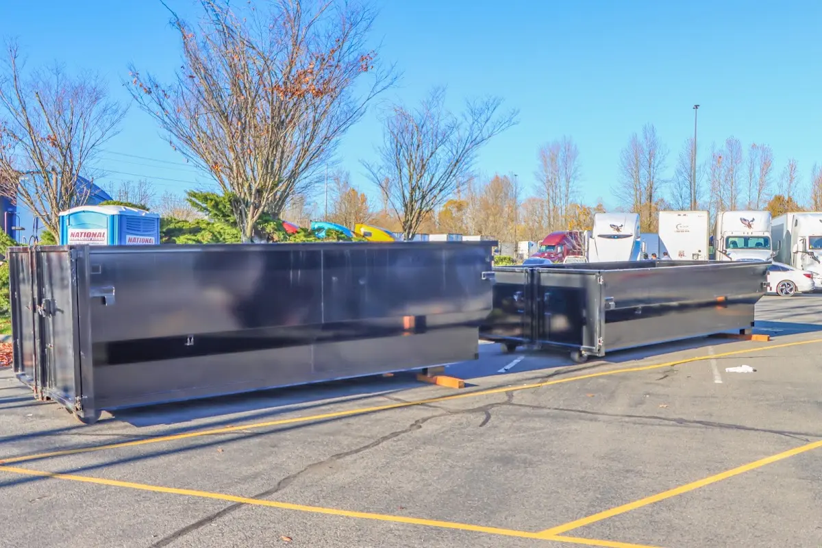 Professional dumpster rental service with roll-off container on residential driveway in Fort Myers Beach